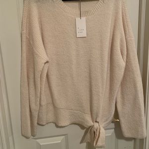 Feminine fuzzy sweater with super cute tie around the border